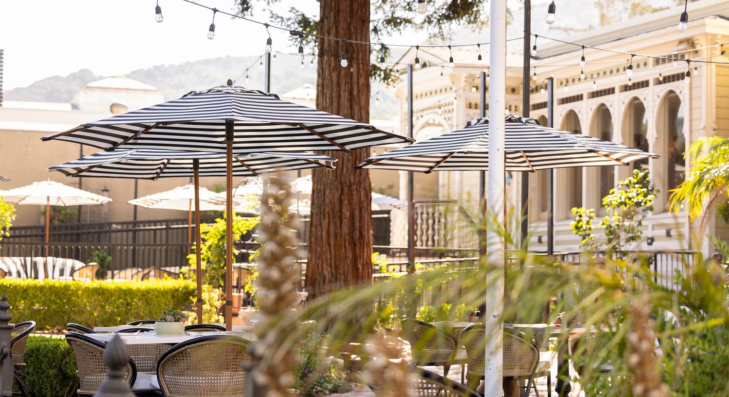 Outdoor dining area with striped umbrellas.