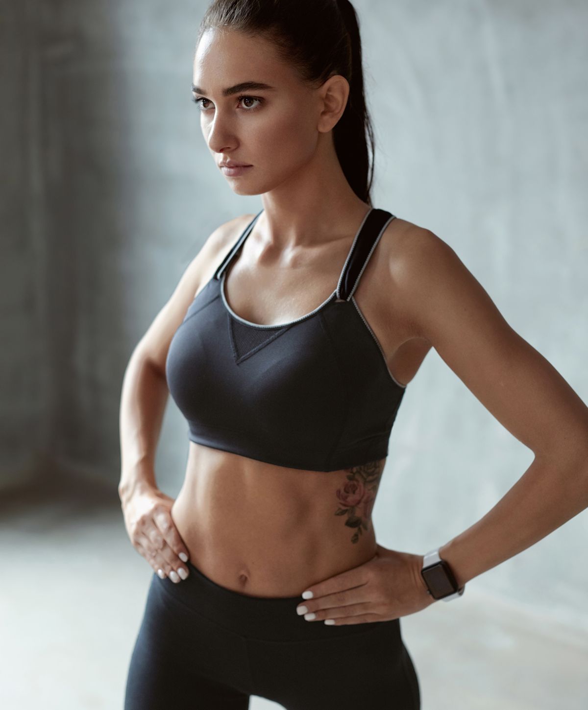 Fit woman in activewear showcasing confident pose.