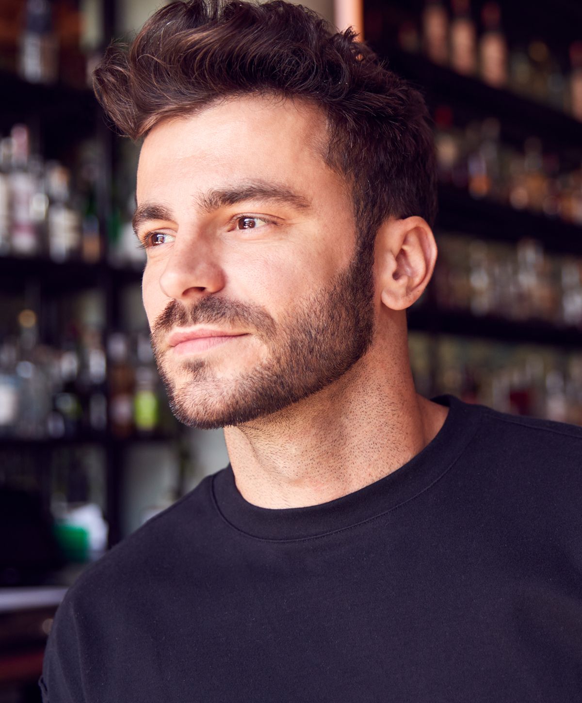 Close-up of man with stylish hair and beard.
