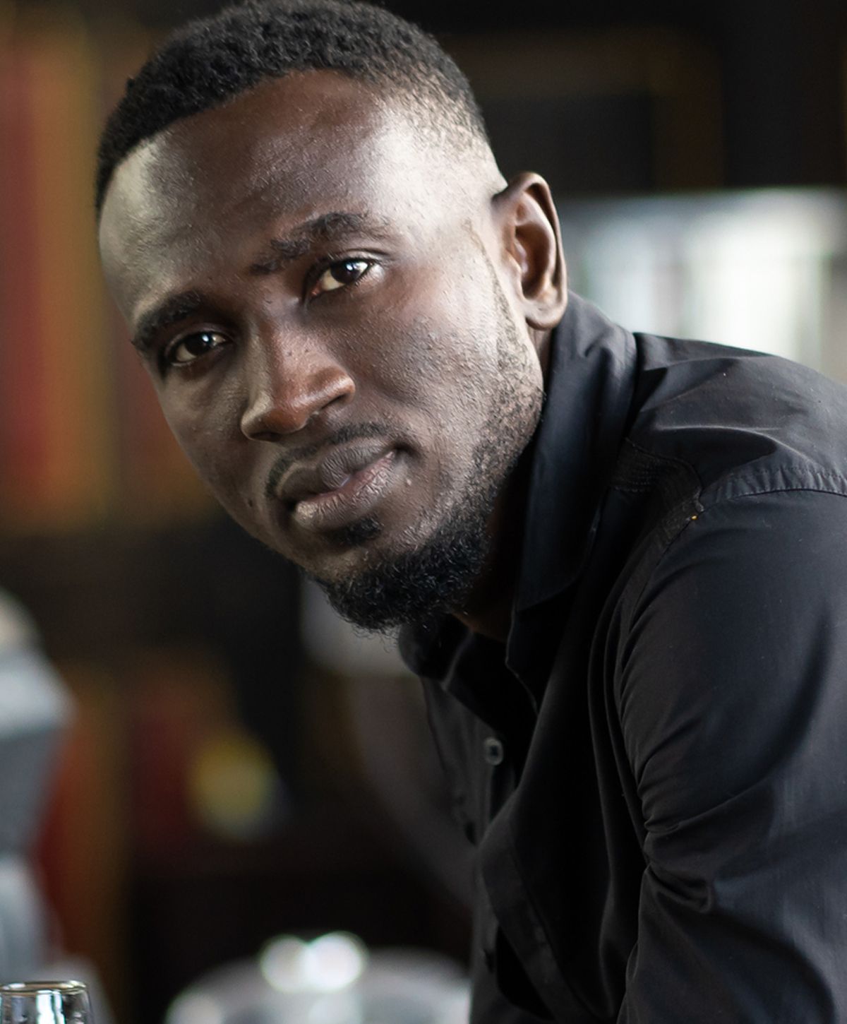 Portrait of a man in a black shirt.