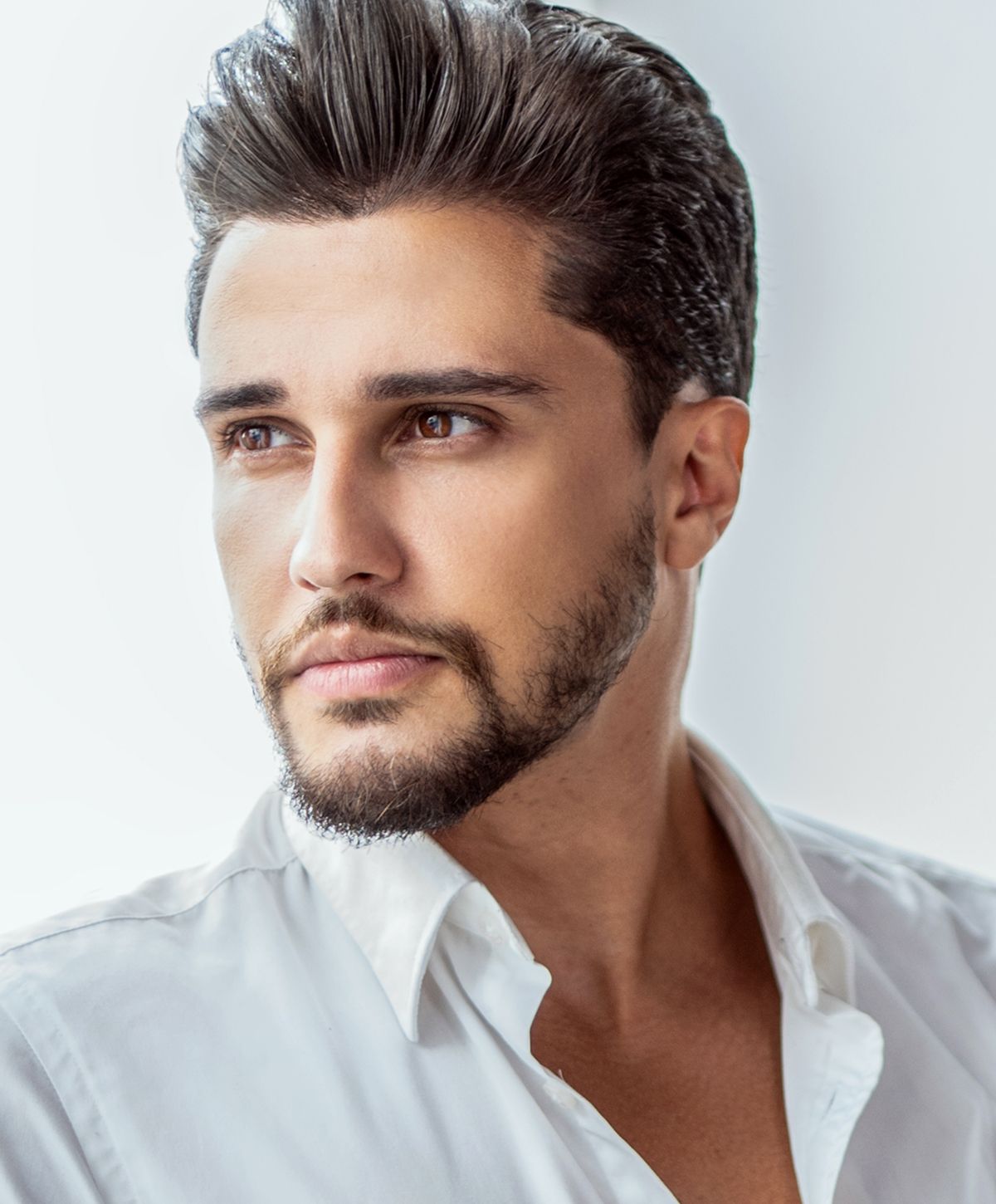 Man with stylish hair and beard, close-up portrait.