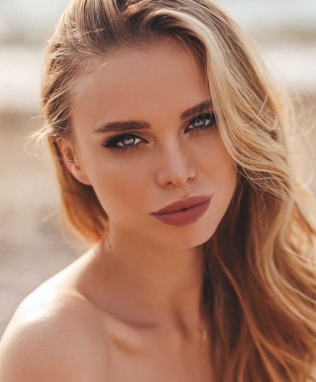 Portrait of a woman with wavy blonde hair.