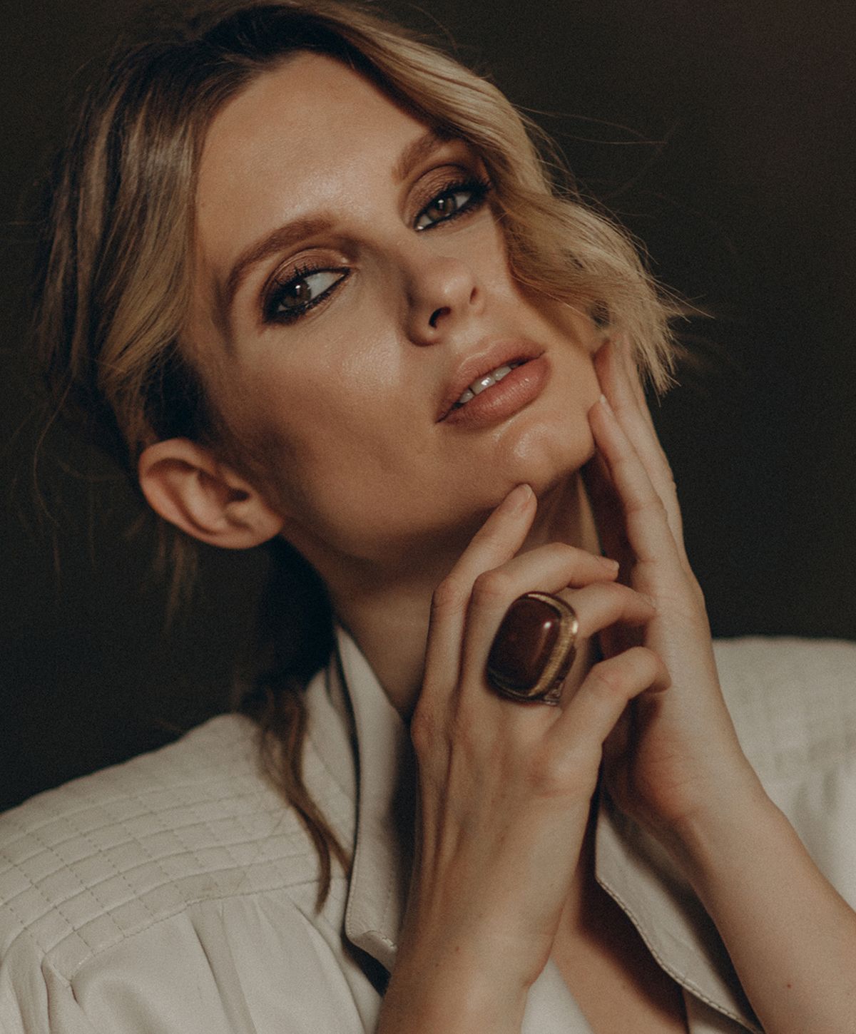 Woman with stylish ring and soft makeup.