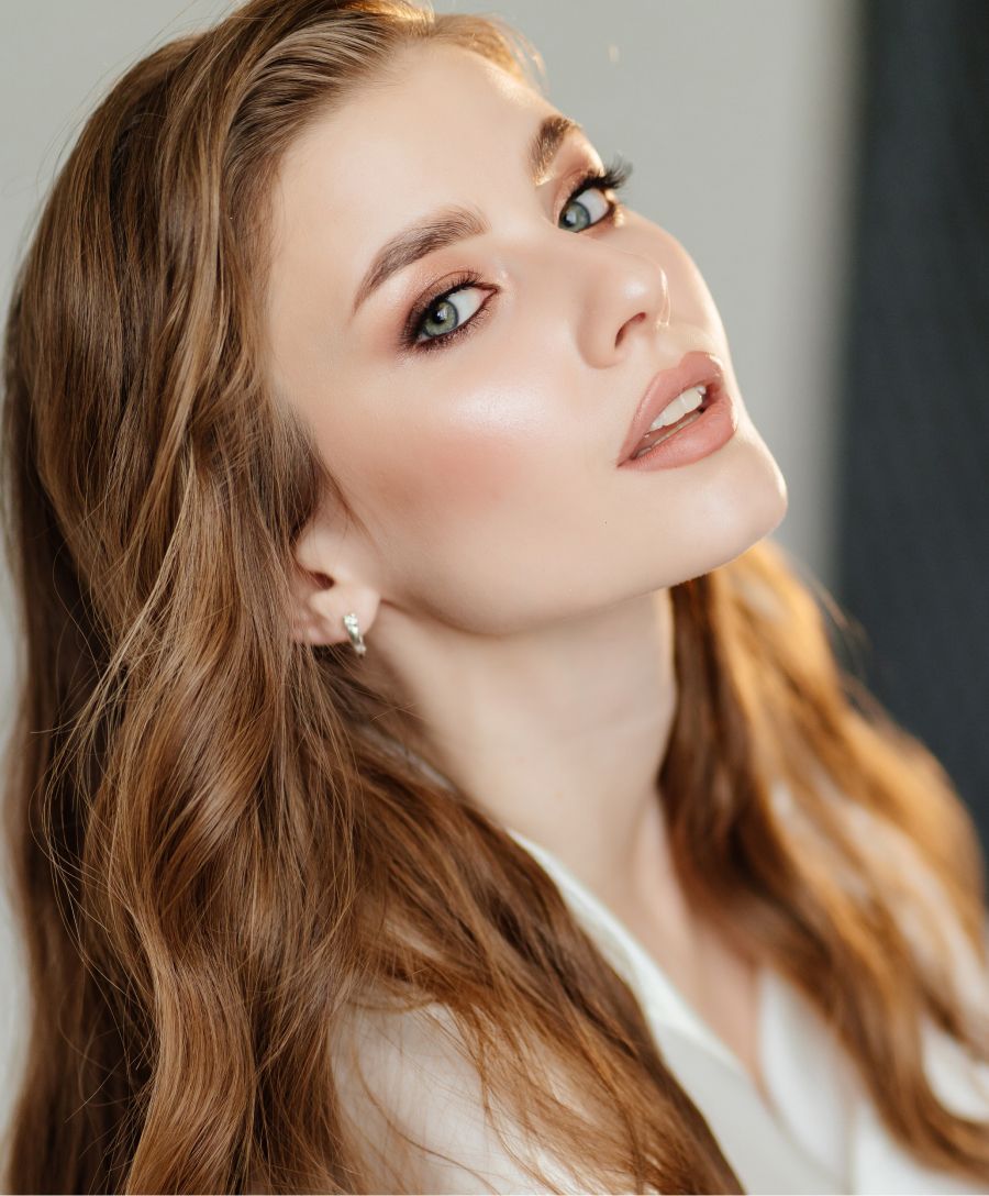 Young woman with long hair and natural makeup.