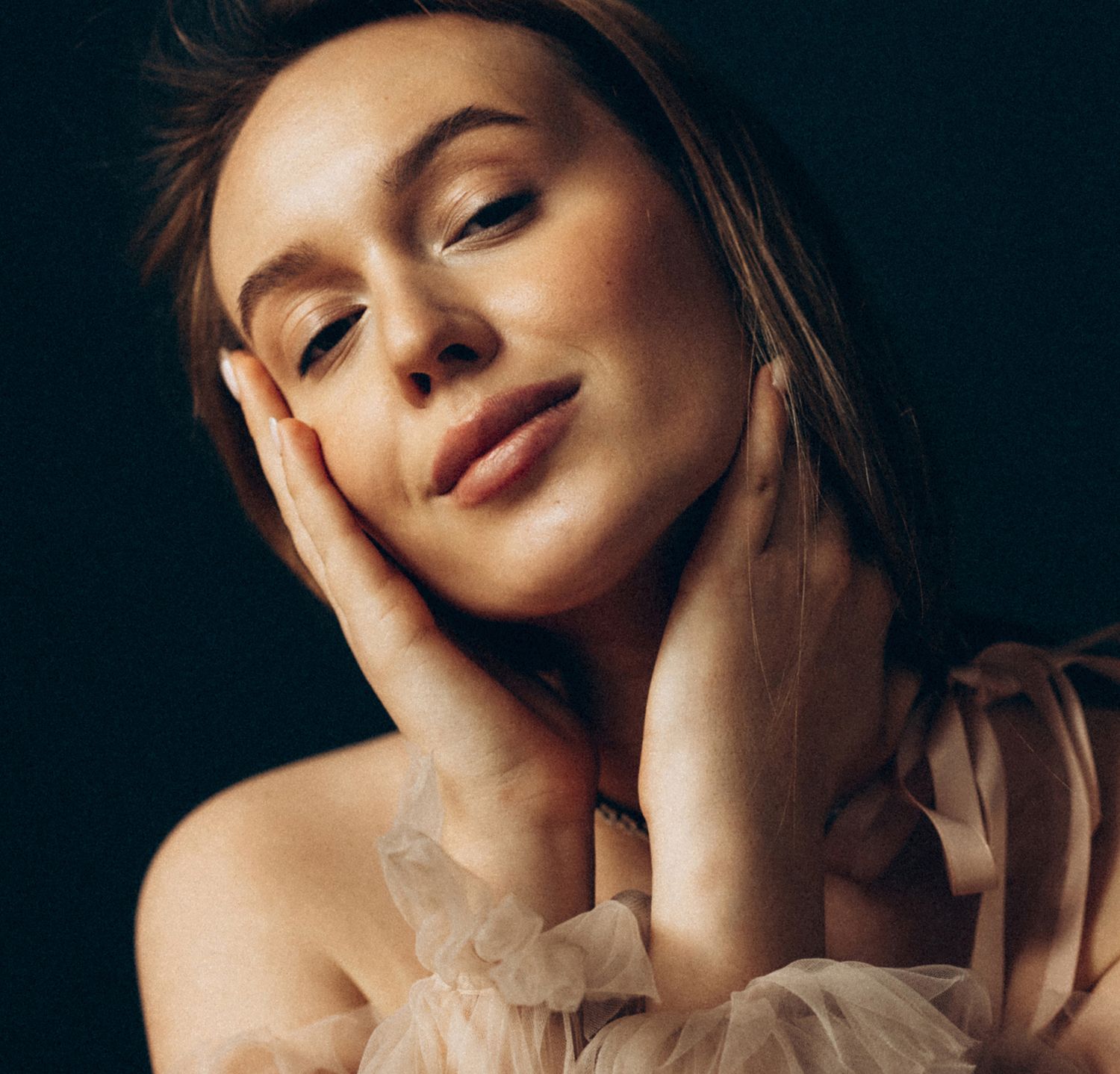Woman in white dress with natural makeup look.