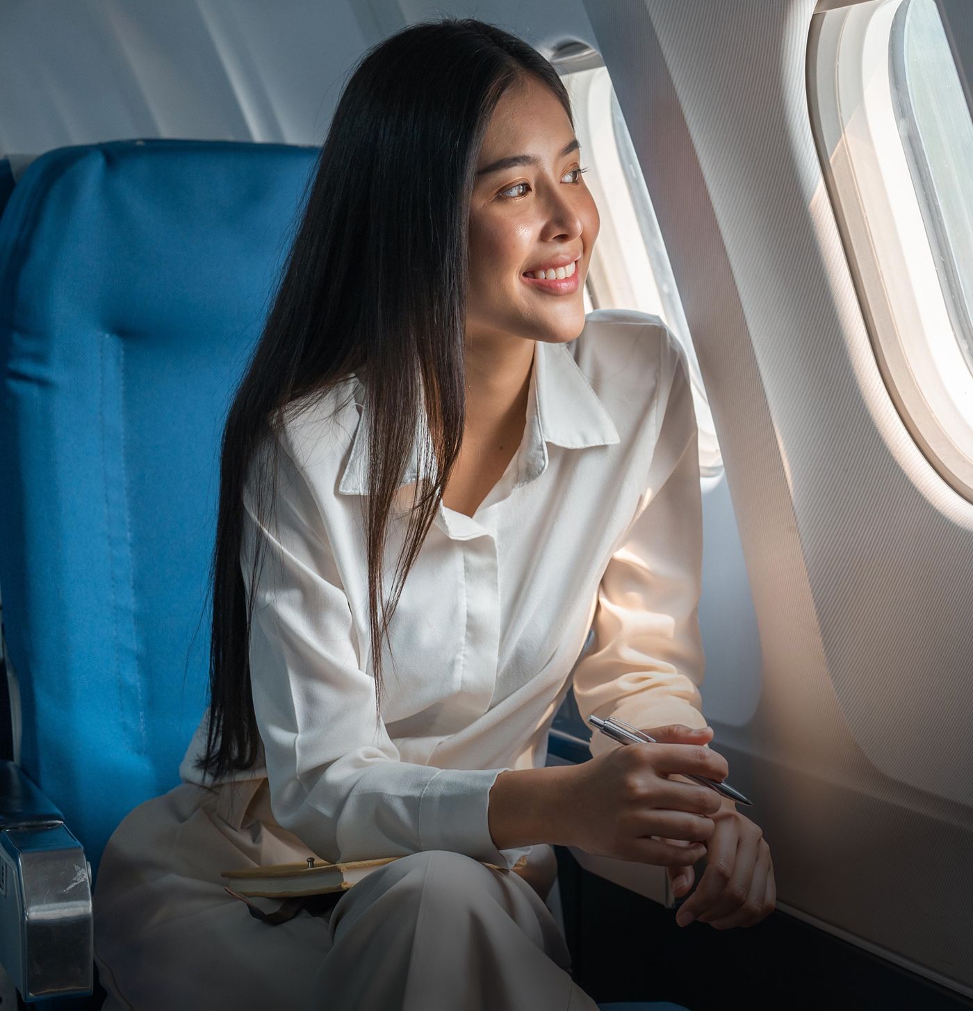 Woman enjoying a flight, looking out the window.
