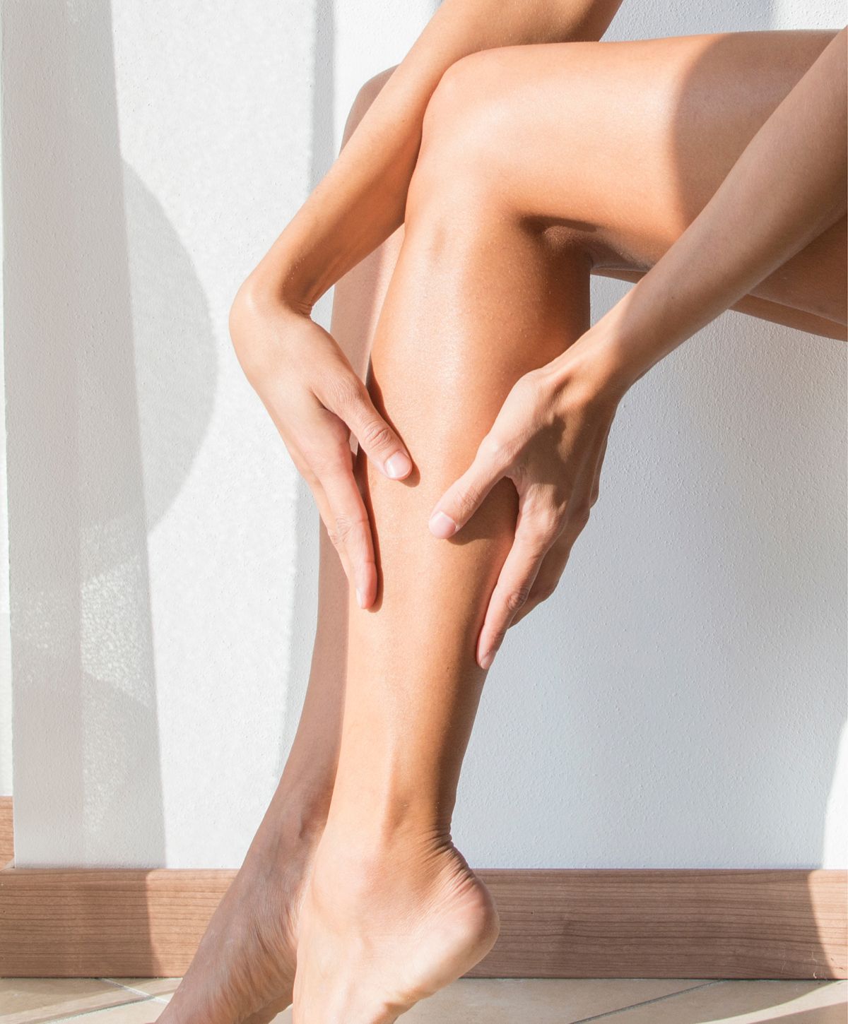 Person applying skincare to their leg.