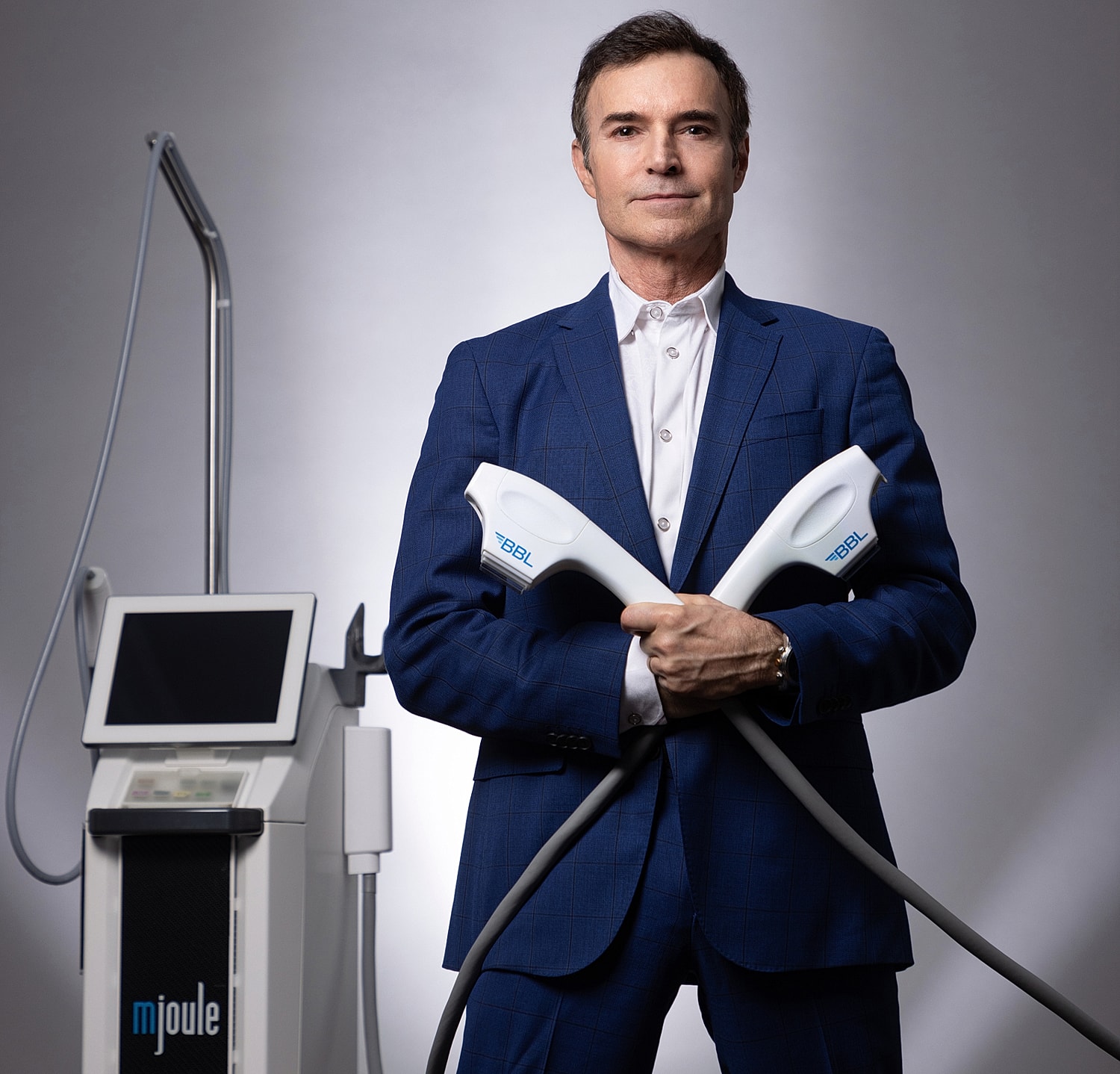 Woman in white dress with natural makeup look.