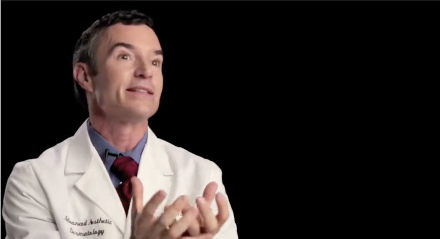 Doctor explaining dermatology concepts with expressive gestures.