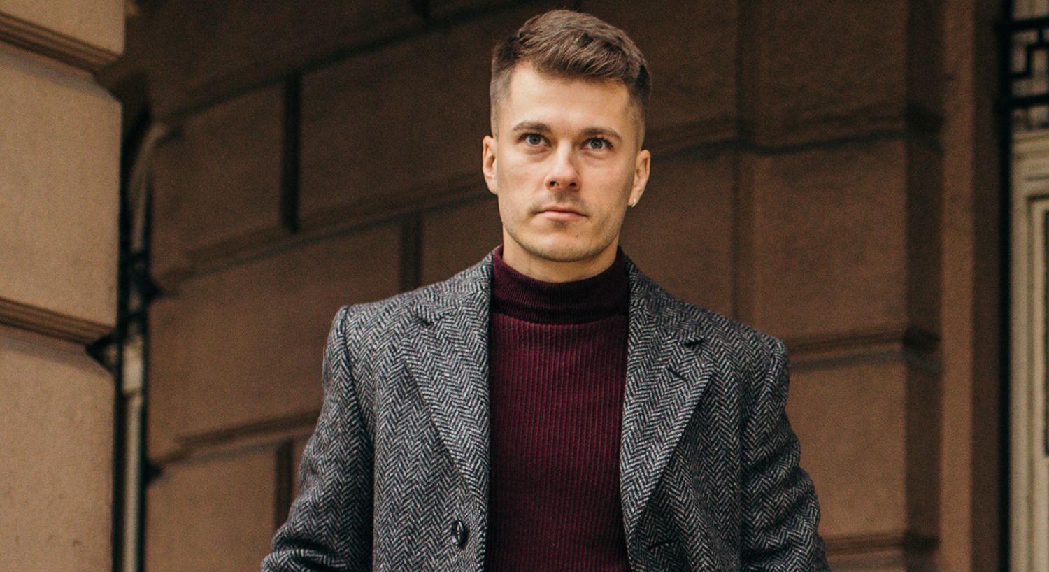 Man in stylish coat and turtleneck sweater.