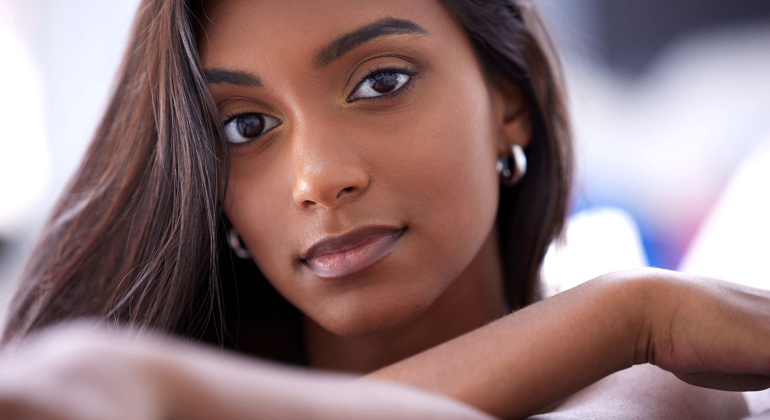 Close-up portrait of a thoughtful young woman.