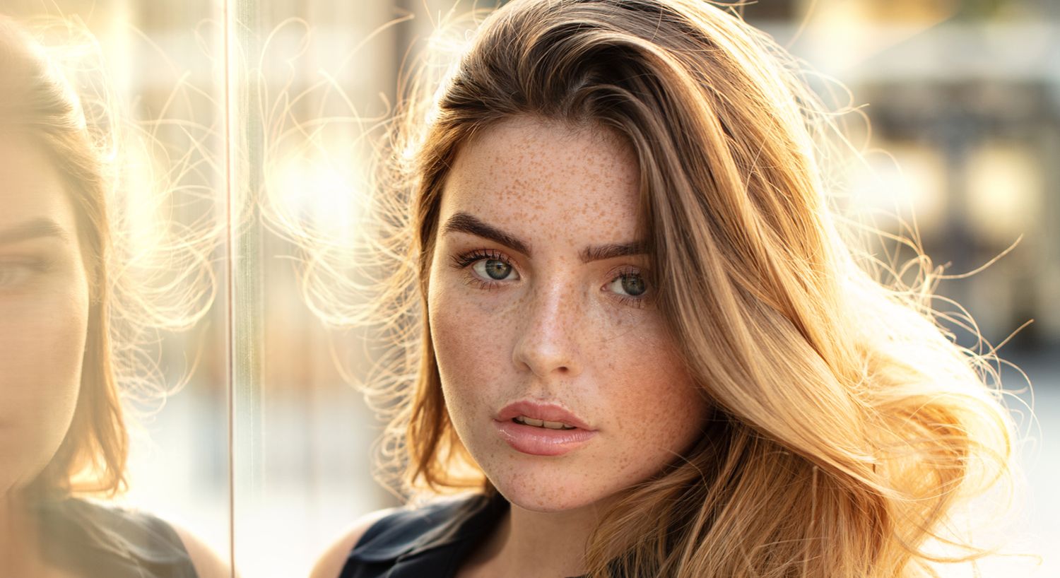 Close-up of a woman with freckled skin.