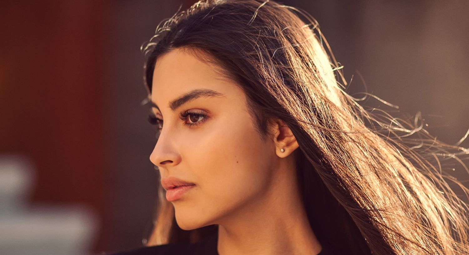 Profile of a woman with flowing hair.