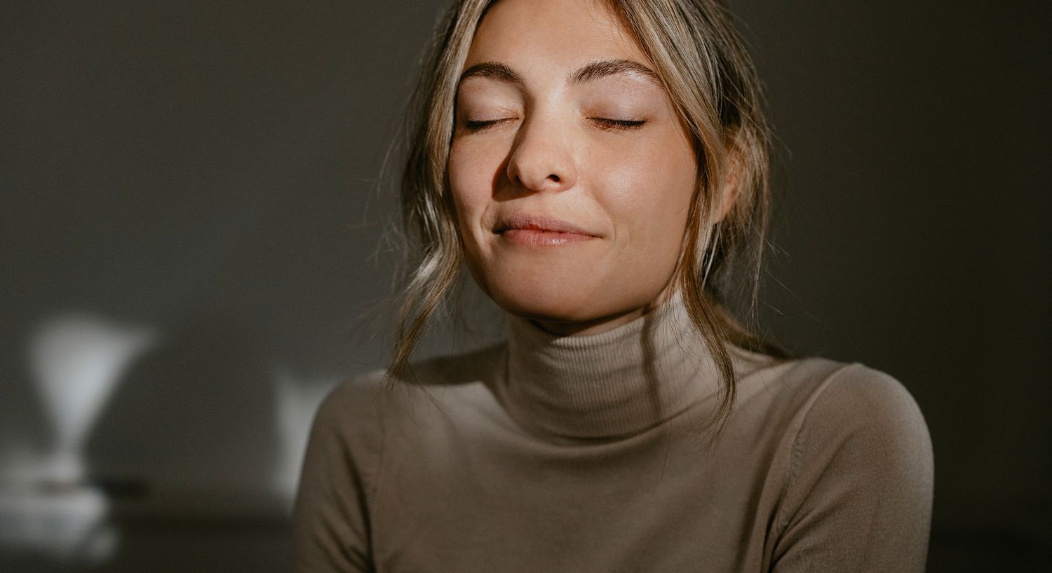 Woman with closed eyes, serene expression.